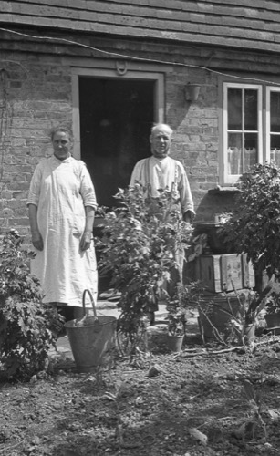 Couple outside a cottage. Although taken in the 1930s it looks like it might have been taken earlier.