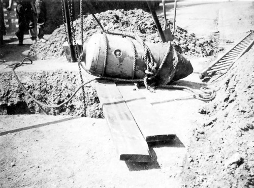 Raising the bomb from the ground.