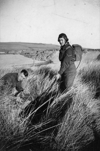 Using a metal detector to find land mines.
