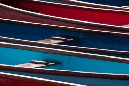 Boats parked side by side providing an abstract pattern.